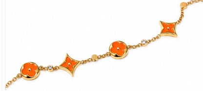 gold-tone charm bracelet featuring stunning turquoise enamel accents.