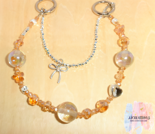 ⸻

Peach & Silver Double Beaded Charm – Phone Chain / Bag Charm with Bow Accent